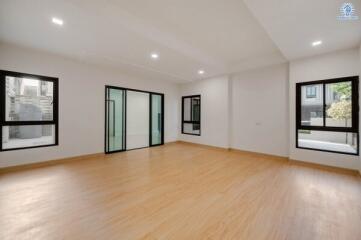 Spacious unfurnished living room with hardwood floors and large windows