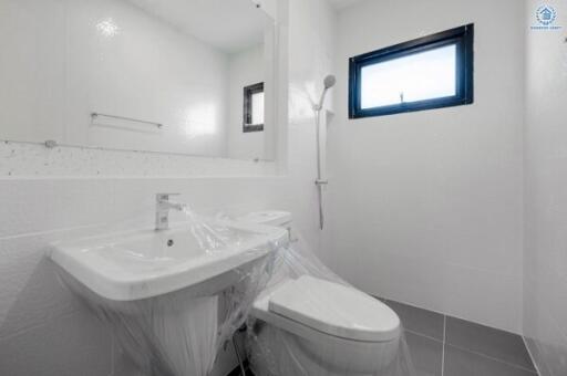 Modern bathroom interior with sanitary fittings still covered in protective plastic