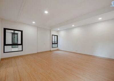 Spacious empty living room with hardwood floors and natural light