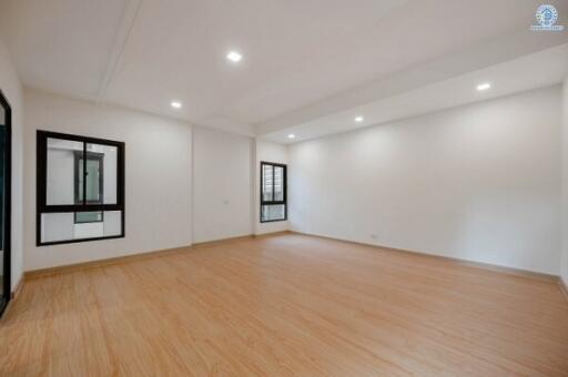 Spacious empty living room with hardwood floors and natural light