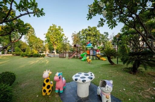 Spacious garden with a playground and seating area