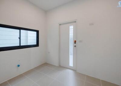 Minimalist bedroom with white walls and tiled flooring