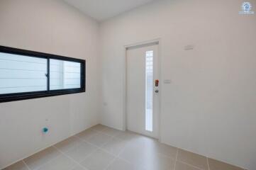 Minimalist bedroom with white walls and tiled flooring