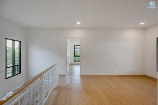 Spacious living room with hardwood floors and ample natural light
