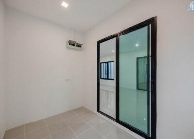 Bright and airy bedroom with sliding door and tiled flooring