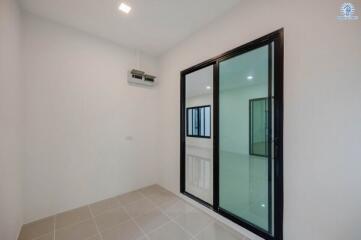 Bright and airy bedroom with sliding door and tiled flooring