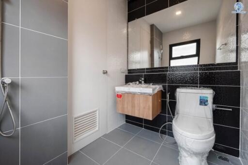 Modern bathroom interior with shower, sink, and toilet