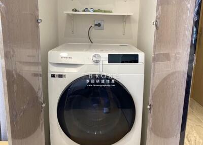 Compact laundry room with a modern Samsung washing machine