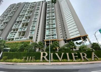 Exterior view of The Riviera residential building with lush landscaping