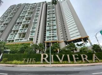 Exterior view of The Riviera residential building with lush landscaping