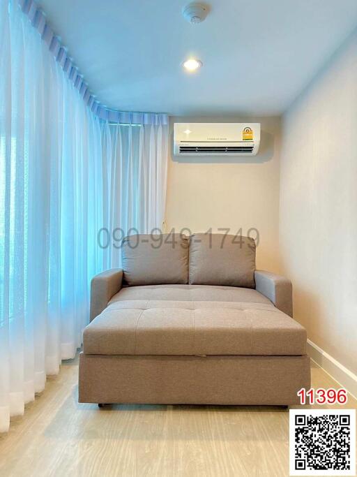 Compact bedroom with a large window and modern air conditioning