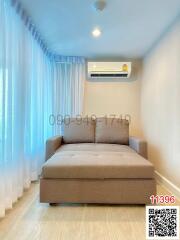 Compact bedroom with a large window and modern air conditioning