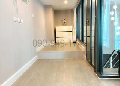 Bright and modern hallway interior with wooden floors and large windows