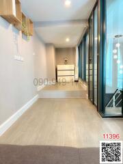 Bright and modern hallway interior with wooden floors and large windows