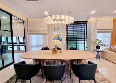 Elegant dining room with chandelier and modern artwork