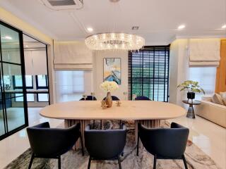 Elegant dining room with chandelier and modern artwork