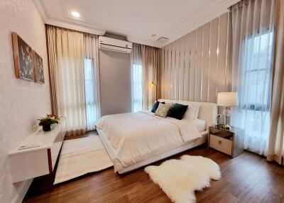 Elegantly furnished bedroom with a comfortable bed and well-lit ambiance