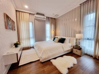 Elegantly furnished bedroom with a comfortable bed and well-lit ambiance