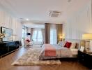 Spacious and elegantly decorated bedroom with ample lighting
