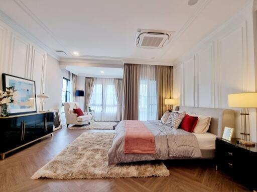 Spacious and elegantly decorated bedroom with ample lighting