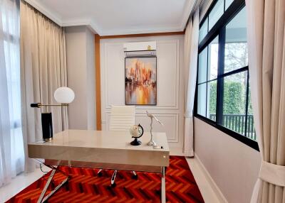 Modern home office with large windows, red carpet and contemporary furnishings