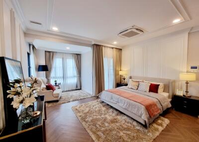 Spacious master bedroom with modern furniture and ample natural light