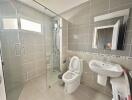 Modern bathroom with walk-in shower and neutral tile finish