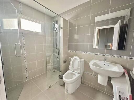 Modern bathroom with walk-in shower and neutral tile finish