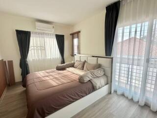 Cozy bedroom with large bed and natural lighting