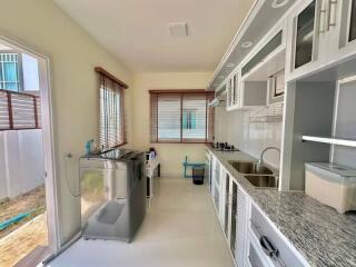 Modern kitchen with stainless steel appliances and granite countertops