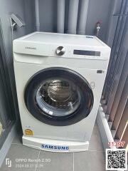 Modern Samsung washing machine in a well-equipped laundry area