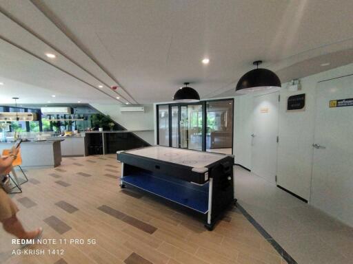 Spacious recreational room with air hockey table and elegant flooring