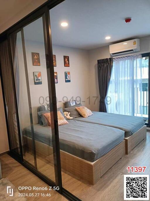 Modern bedroom with large bed and sliding glass wardrobe