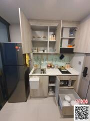 Modern compact kitchen with appliances and storage shelves