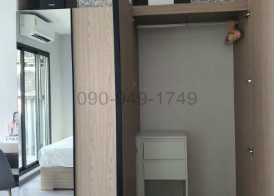 Modern bedroom with built-in wardrobe and air conditioning unit