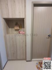 Apartment entrance with wooden shoe cabinet and front door