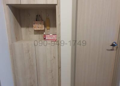 Apartment entrance with wooden shoe cabinet and front door