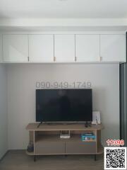 Minimalist living room with wall-mounted cabinets and a television