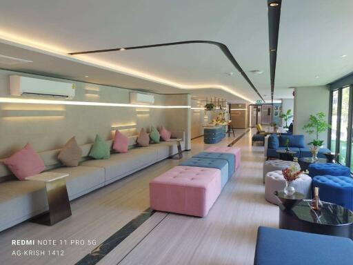 Modern and spacious lounge area with colorful seating and ambient lighting