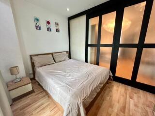 Cozy bedroom with large bed and frosted glass doors