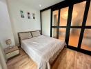 Cozy bedroom with large bed and frosted glass doors