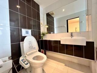 Modern bathroom with black and white tiling and sleek fixtures