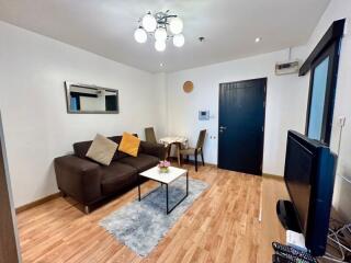 Spacious and well-lit living room with modern furnishings