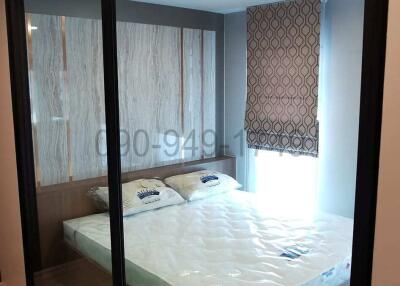 Modern bedroom with ample lighting and large mirror wardrobe doors