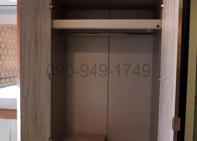 Modern built-in wardrobe in a bedroom with open doors