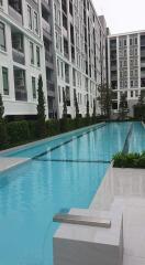 Swimming pool area with residential buildings in the background