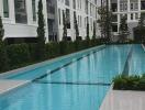 Swimming pool area with residential buildings in the background