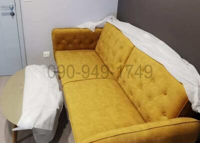 Modern bedroom with yellow sofa and grey flooring