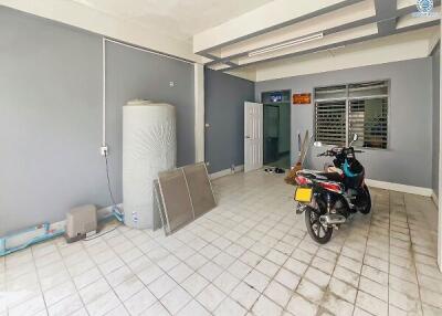 Spacious garage with motorcycle parking and storage space