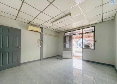 Spacious empty room with tiled floor, air conditioning, and natural light